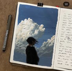 an open notebook with a drawing of a person standing in front of a cloudy sky