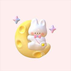 a white bunny sitting on the moon with stars