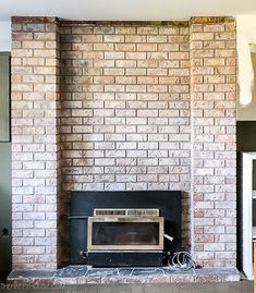 a brick fireplace with a microwave on the mantle