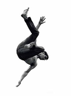 a man in the air doing a handstand on his skateboard against a white background