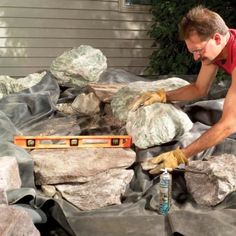 a man in red shirt working on rocks