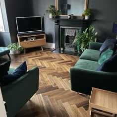 a living room filled with furniture and a flat screen tv on top of a wooden floor