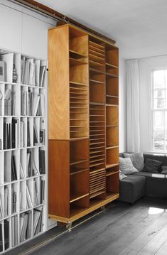 a living room filled with furniture and bookshelves