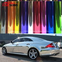 a silver car parked in front of a multicolored building