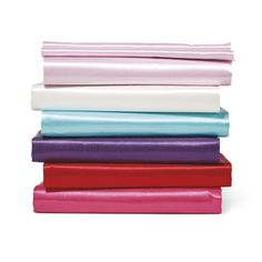 a stack of different colored sheets on top of each other