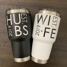 two black and white tumblers sitting next to each other on a wooden floor with the words hubs 2013 - 2016 written on them