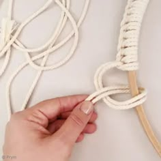 someone is tying the rope on top of the headbands to make it look like they are holding something in their hand