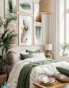 a bedroom with white walls and green bedding, pictures on the wall above the bed