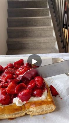 strawberry shortcakes with whipped cream on top sitting on a table next to stairs