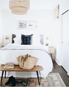 a bedroom with a bed, rugs and pictures on the wall above it in black and white