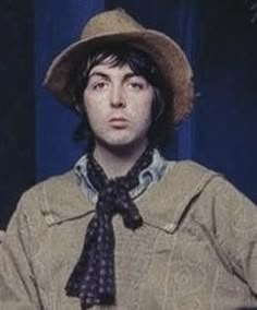 a young man wearing a hat and tie