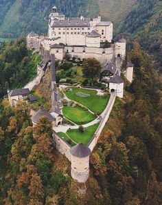 an aerial view of a castle in the mountains