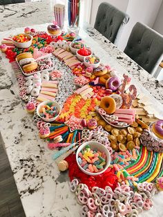 a table filled with lots of donuts and other treats on it's side