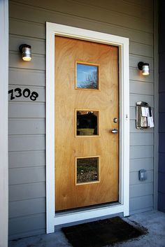 the front door of a house with two lights on