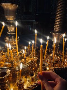 a person is lighting candles in a church