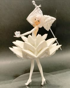 a figurine that is sitting on top of a flower