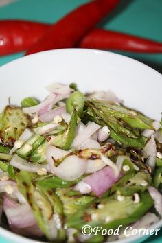 a white bowl filled with onions and green beans