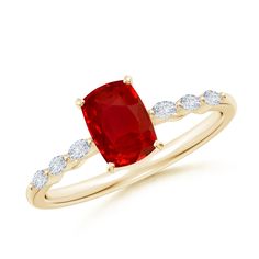 a yellow gold ring with a red stone and white diamonds