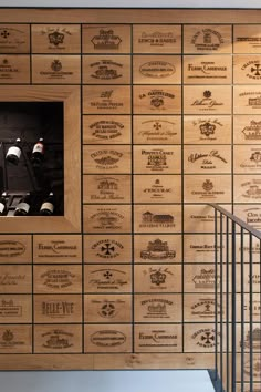 a wall with wine bottles on it and stairs leading up to the top floor in front of them