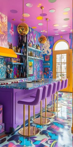 a brightly colored bar with purple chairs and chandelier hanging from the ceiling above it