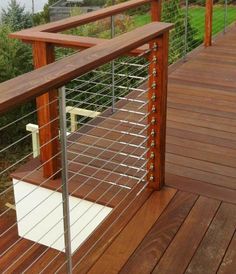 a wooden deck with metal rails and railings