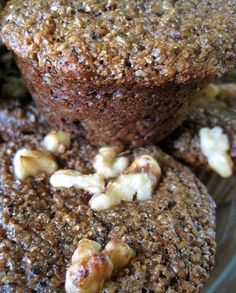 three muffins stacked on top of each other in a glass bowl with nuts