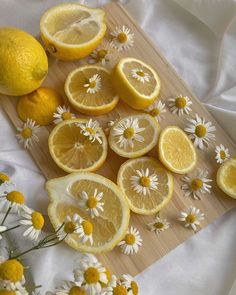 lemons and daisies cut up on a cutting board