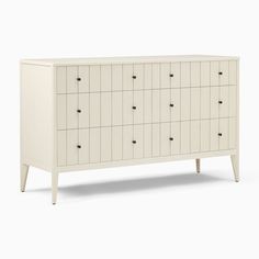 a white dresser with many drawers on it