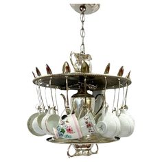 a chandelier with cups and saucers hanging from it