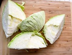 four pieces of lettuce on a cutting board