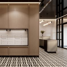 an office with wooden cabinets and black and white patterned flooring, along with two planters on the wall