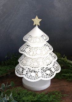 a small white christmas tree on top of a wooden table