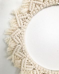 a white doily with fringes on top of it