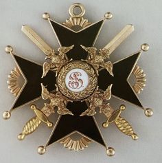 a gold and black star with two crossed swords