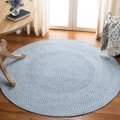 a person sitting on a chair in front of a rug that looks like a circle