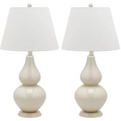 pair of white ceramic lamps with shades on each lamp and one light off the side