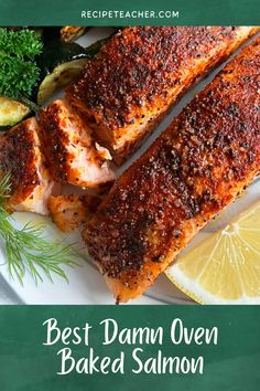 the best damn oven baked salmon on a plate with lemons, parsley and dill