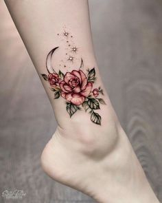 a woman's foot with flowers and a crescent tattoo on the left side of her leg