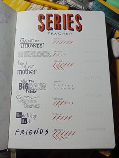 an open notebook with writing on it next to pencils and markers, including the title game of thrones