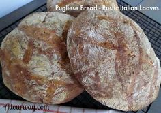 three round breads sitting on top of a cooling rack