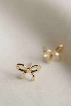 Rumor has is that 2024 is the year of BOWS! These super cute, bow stud earrings are the dainty, delicate, and prefect for all day wear. Includes two gold or silver-plated bow studs Approx. 1/2" Choose from either gold or silver Bow Tie Earrings, Cute Gold Bow Earrings, Gold Bow Tie Earrings For Gift, Gold Earrings With Bow Tie Detail For Gift, Cute Bow Earrings For Gifts, Cute Anniversary Jewelry With Bow, Small Gold Cute Earrings, Western Earrings Fashion, Cute Earing