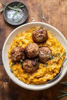 a bowl filled with pasta and meatballs