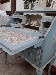 a blue desk with drawers and an open drawer