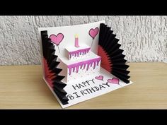 a birthday card with a cake on it and hearts coming out of the candle holder