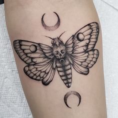 a black and white moth with crescent moon tattoo on the thigh, done by me