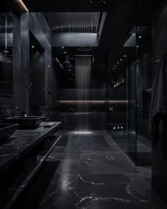 a bathroom with black marble floors and walls