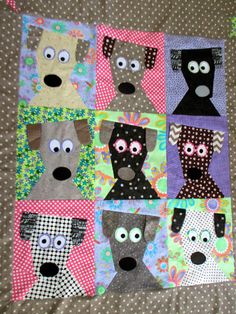 a quilted square with four different dogs on it's sides and one has eyes that look like they are looking at something