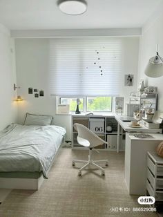 a bedroom with a bed, desk and chair in it next to a small window