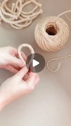 two hands are holding twine and yarn