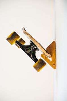 a skateboard mounted to the side of a wall with wooden boards on it's sides